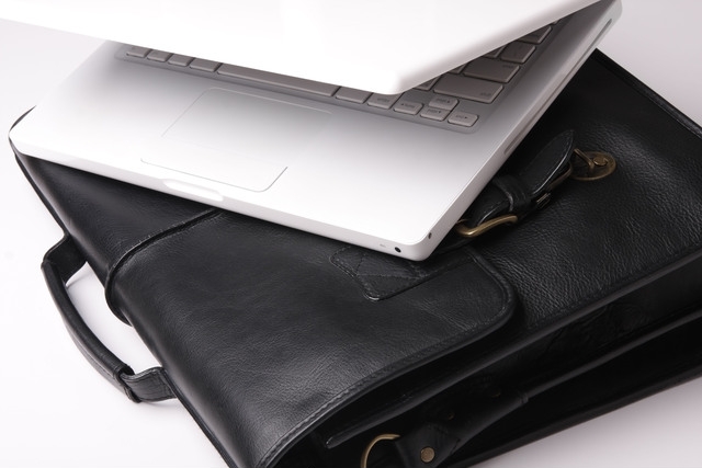 Classic black leather laptop briefcase with multiple compartments for organization, perfect for professionals.

