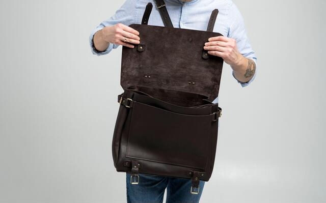 Stylish black leather messenger bag for urban fashionistas on the go.
