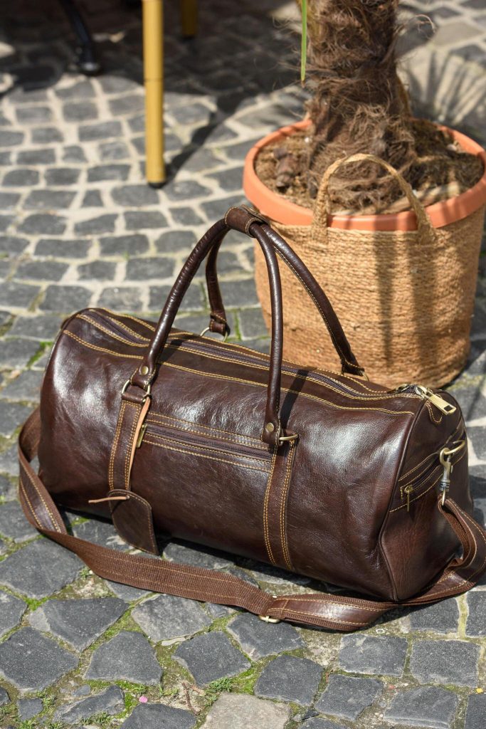 Durable brown leather weekend bag for men, spacious compartments, ideal for travel adventures. 