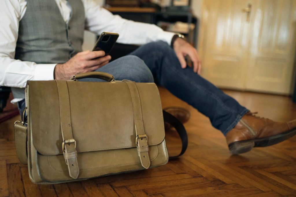 A sleek  leather messenger bag with adjustable strap and spacious compartments.

